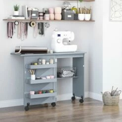 HOMCOM Folding Sewing Table, Rolling Utility Work Station Side Desk with 3-Tier Storage Bins, Shelf, and Lockable Casters, Grey